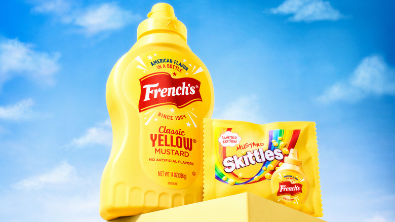 bottle of french's mustard packet of mustard skittles sky background