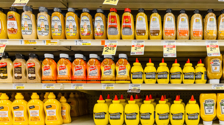 Assorted mustard brands on a shelf