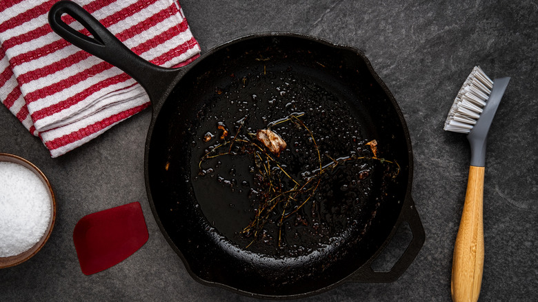 Dirty cast iron skillet and brush