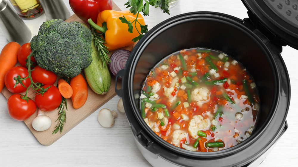 Vegetables on cutting board and in slow cooker