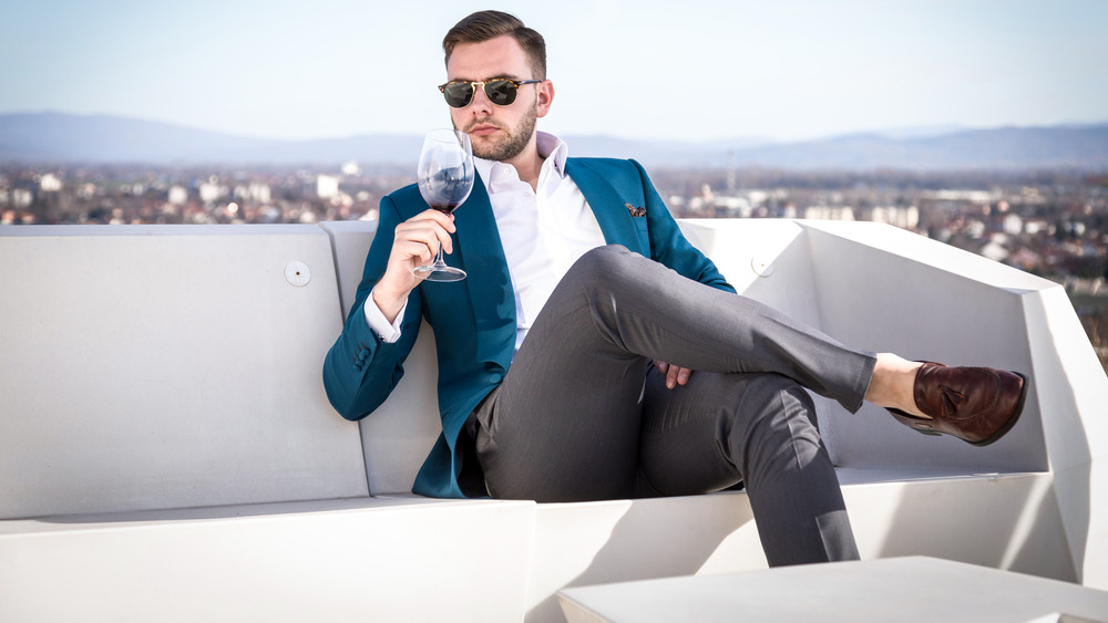 Wealthy man drinking wine