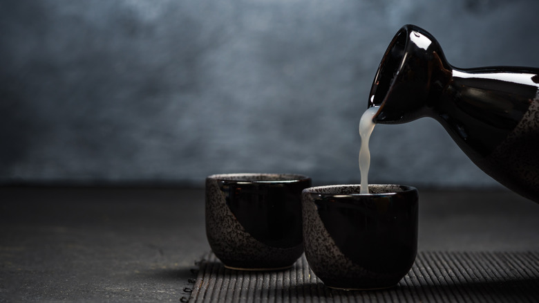 Sake pouring into sipping cups