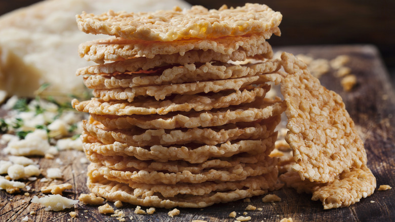 Cheese crisps on wood 