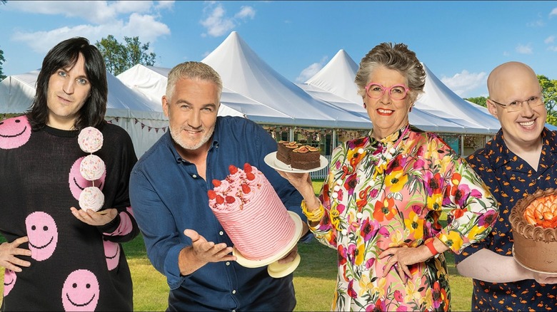 GBBO hosts and judges holding cakes