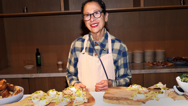 Chef and baker Nancy Silverton in plaid shirt and apron in a kitchen
