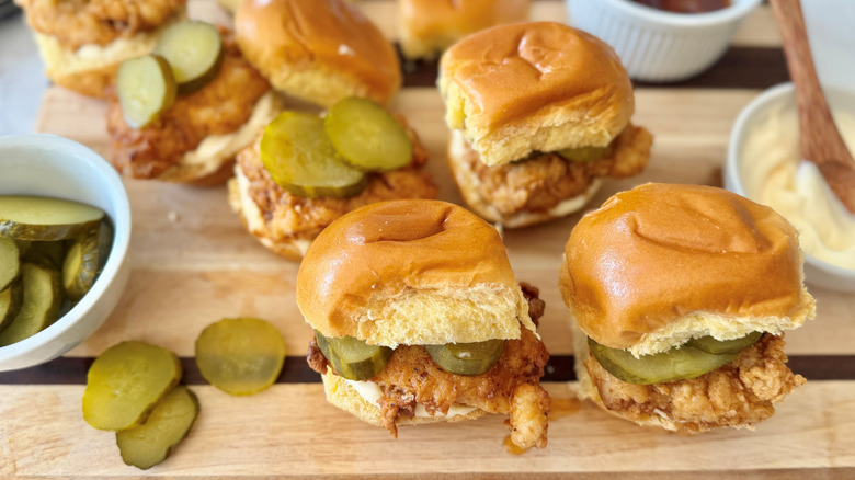 Nashville hot chicken sliders on wooden board