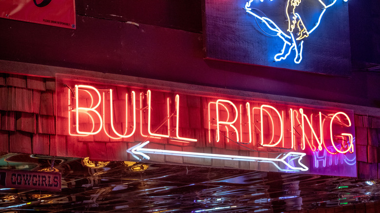 Neon bull riding sign 