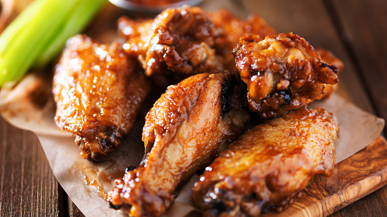 Cooked chicken wings on a plate with celery