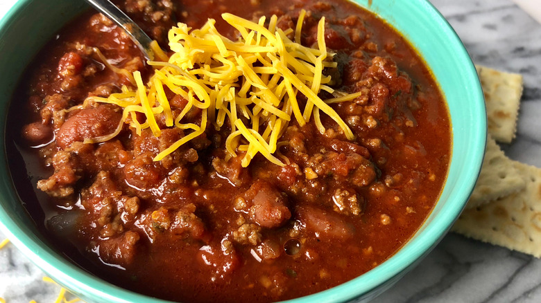Bowl of chili topped with shredded cheese