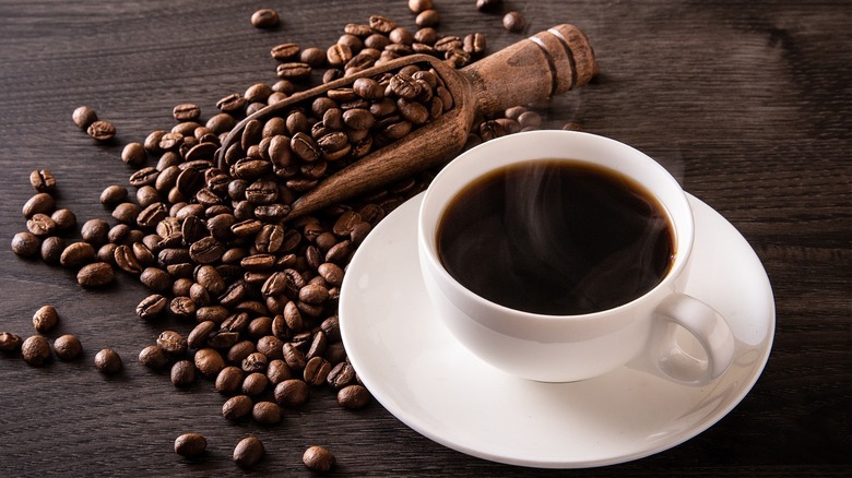 White of coffee and beans around saucer