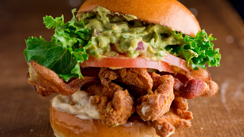 fried chicken sandwich with bacon and avocado