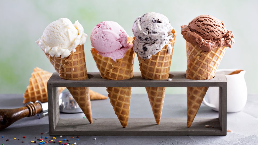 four ice cream scoops of different flavors in a holder