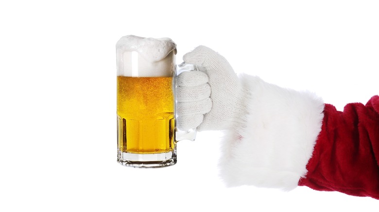 Santa's arm holding pint of beer