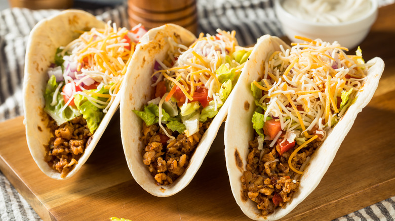 3 tacos on a cutting board