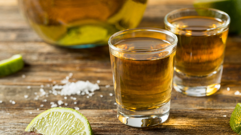 two tequila shots with salt and lime wedge