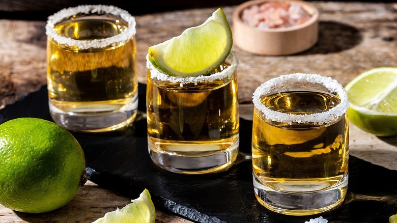 Tequila shot with salt rims and lime wedges