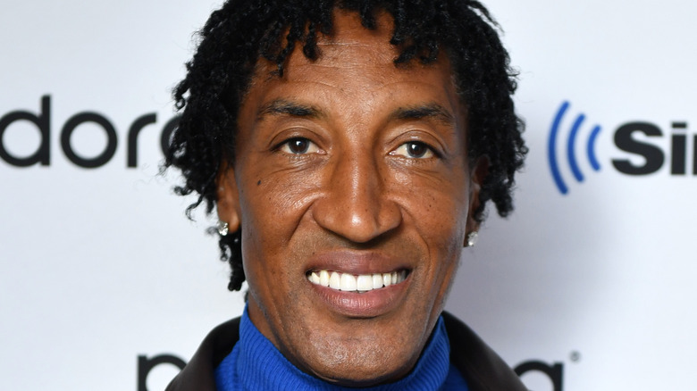 Scottie Pippen smiles in blue turtleneck 