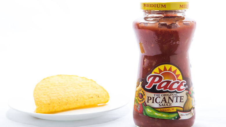 Bottle of Pace salsa next to taco shell