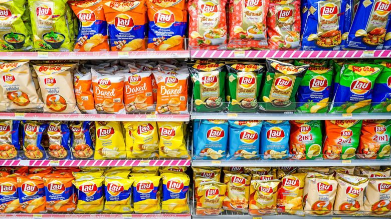 Shelf stocked with assorted chips