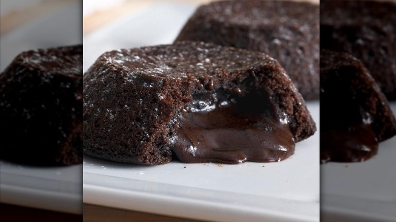 Two chocolate lava crunch cakes on a white plate 