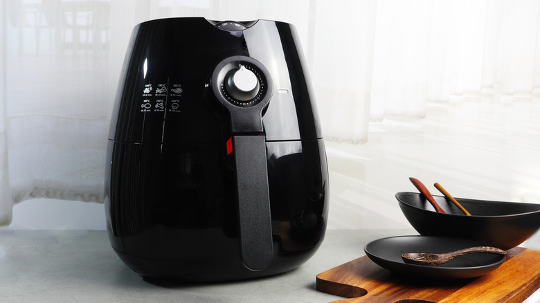 Air fryer next to tableware