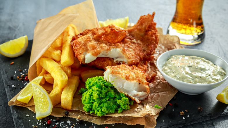 fried fish with French fries tartar sauce malt vinegar and lemon