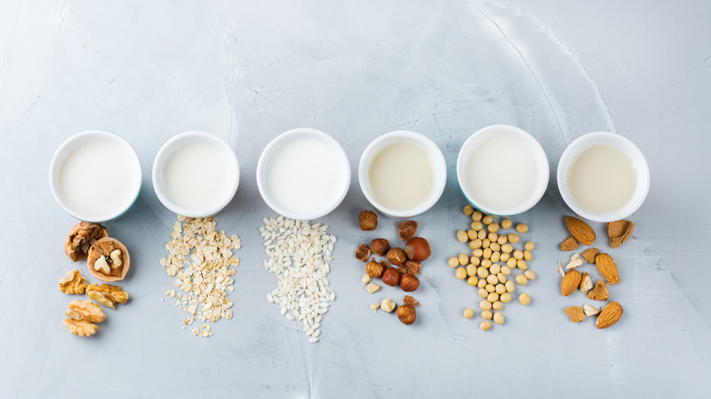 Different kinds of milk next to nuts