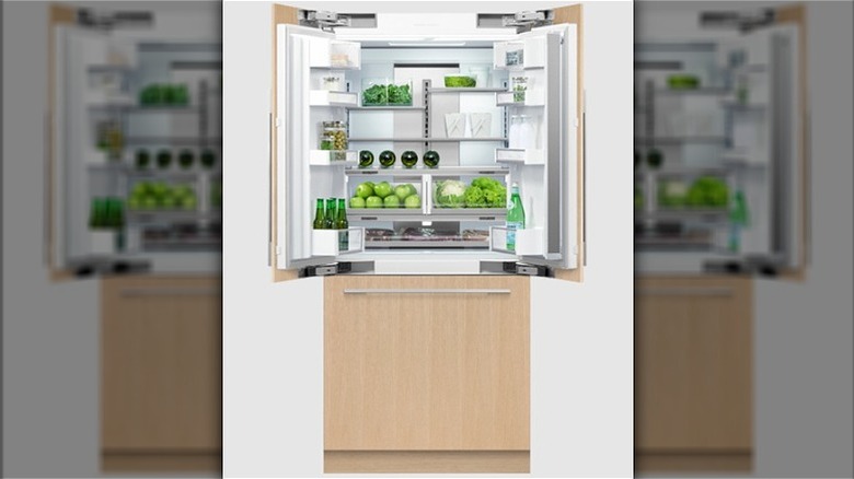 Fisher & Paykel paneled integrated fridge open with food inside