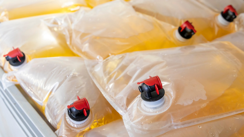 Bags of white wine in cooler.