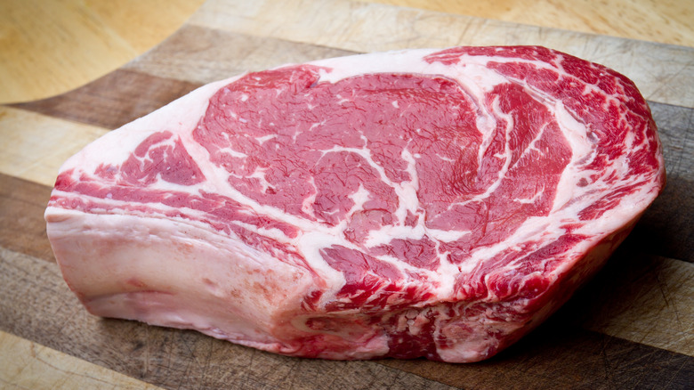raw steak on cutting board
