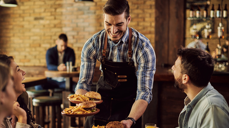 Restaurant server and guests 