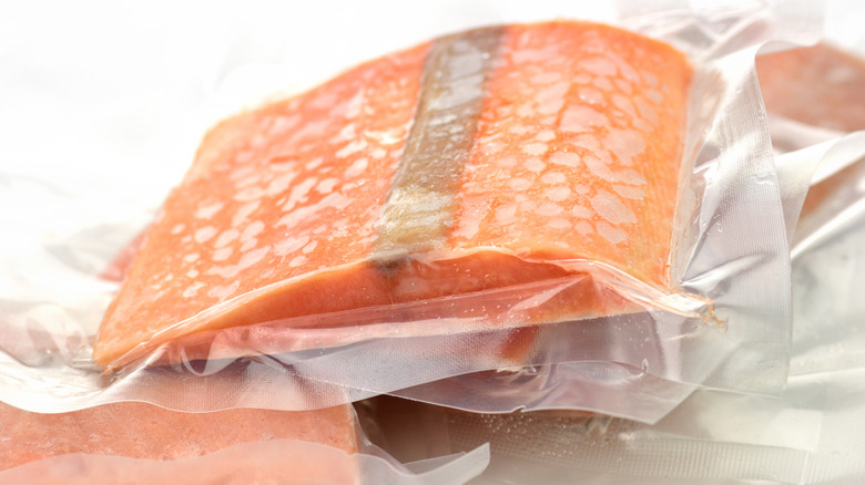 A frozen, vacuum-sealed cut of salmon