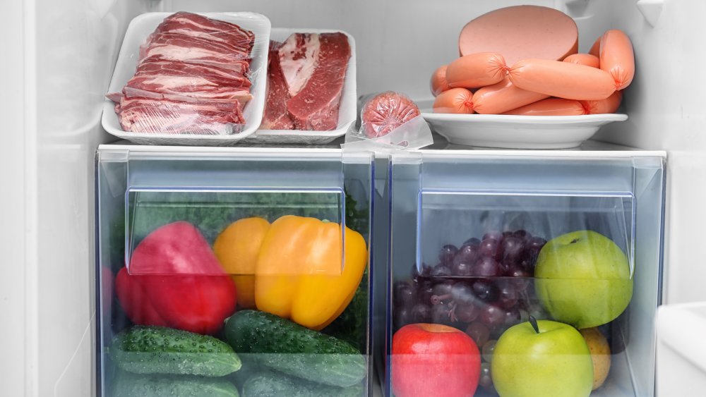 package of raw meat on a shelf in the refrigerator