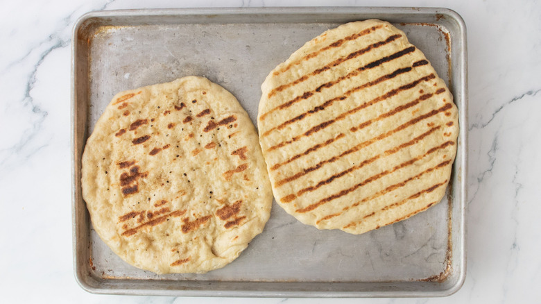 Grilled pizza crusts on sheet pan