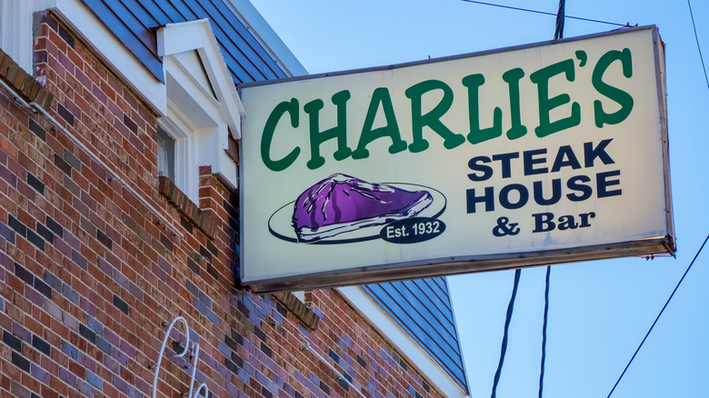 Charlie's Steak House sign on brick building