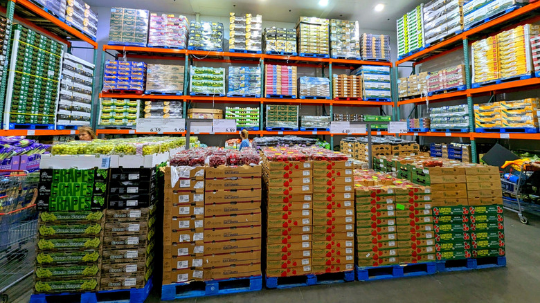 Costco fresh produce section with crates of fruits and vegetables