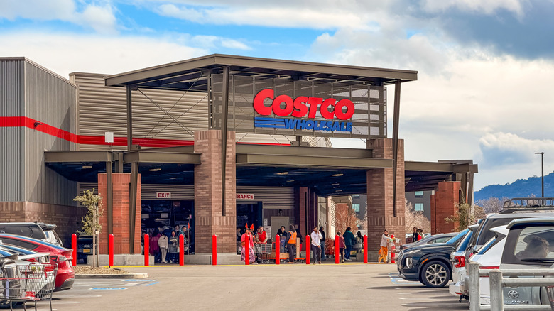 Costco storefront with customers standing in the entrance