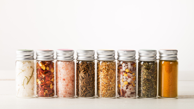 A row of spice containers filled with different spices 