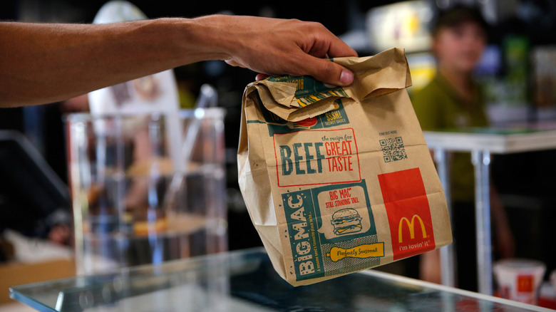 person holding McDonald's takeout bag