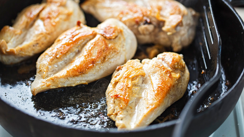 chicken cooking in a pan