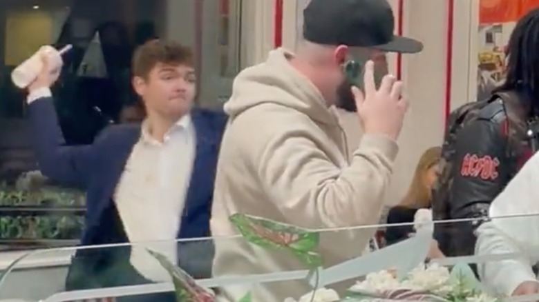 Nick Fuentes throwing drink