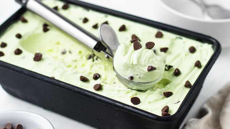 Mint chocolate chip ice cream scooped out of loaf pan