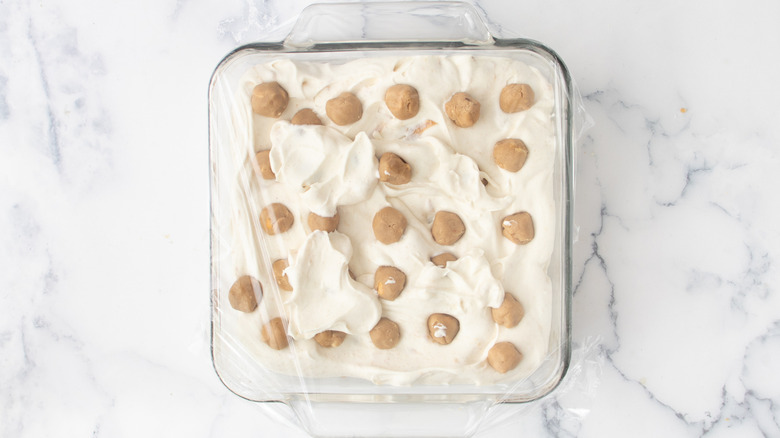 plastic covered ice cream and cookie dough balls in glass dish