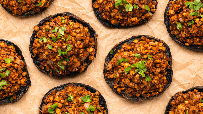 Vegan stuffed portobello mushrooms on parchment paper