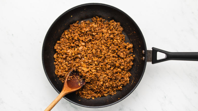 Lentil and walnut mixture sauteing in frying pan