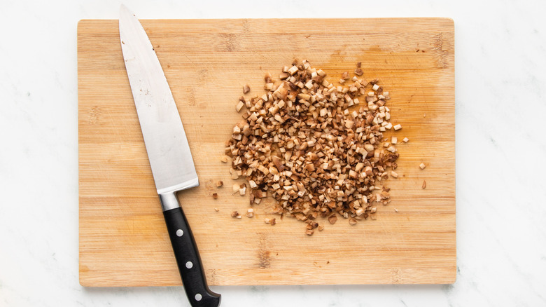 Finely diced mushroom stems on cutting board