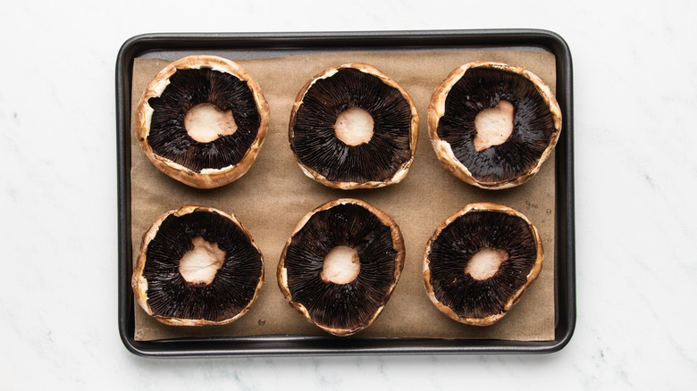 Portobello mushrooms on baking sheet