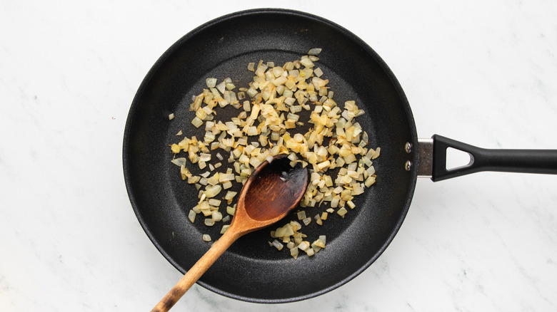 Sauteed diced onion in frying pan