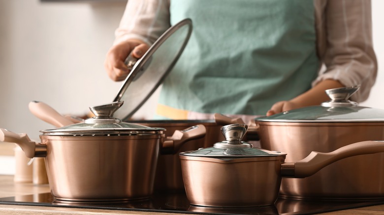 A set of pots and pans with lids on