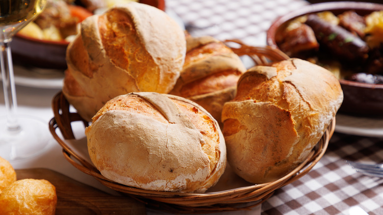 Basket of dinner rolls on table